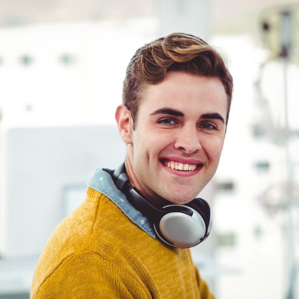 smiling young man with headphones working in moder 2026 01 09 09 13 25 utc.jpg